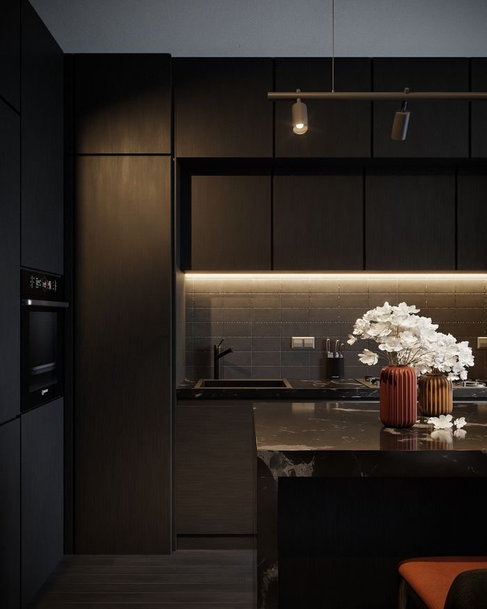 A sleek, modern kitchen with a dark theme and illuminated cabinets, highlighting a stylish kitchen island.